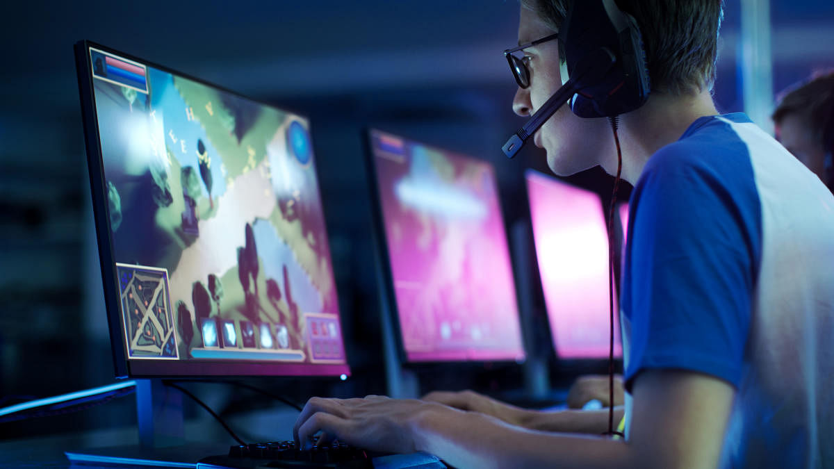 Team of Professional eSport Gamers Playing in Competitive MMORPG/ Strategy Video Game on a Cyber Games Tournament. They Talk to Each other into Microphones. Arena Looks Cool with Neon Lights.Team of Professional eSport Gamers Playing in Competitive MMORPG