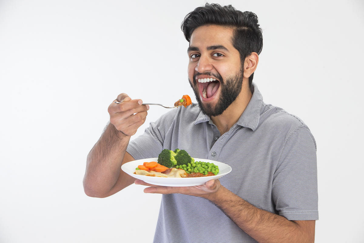 Handsome Indian man eating home cooked mealIndian Man Eating
