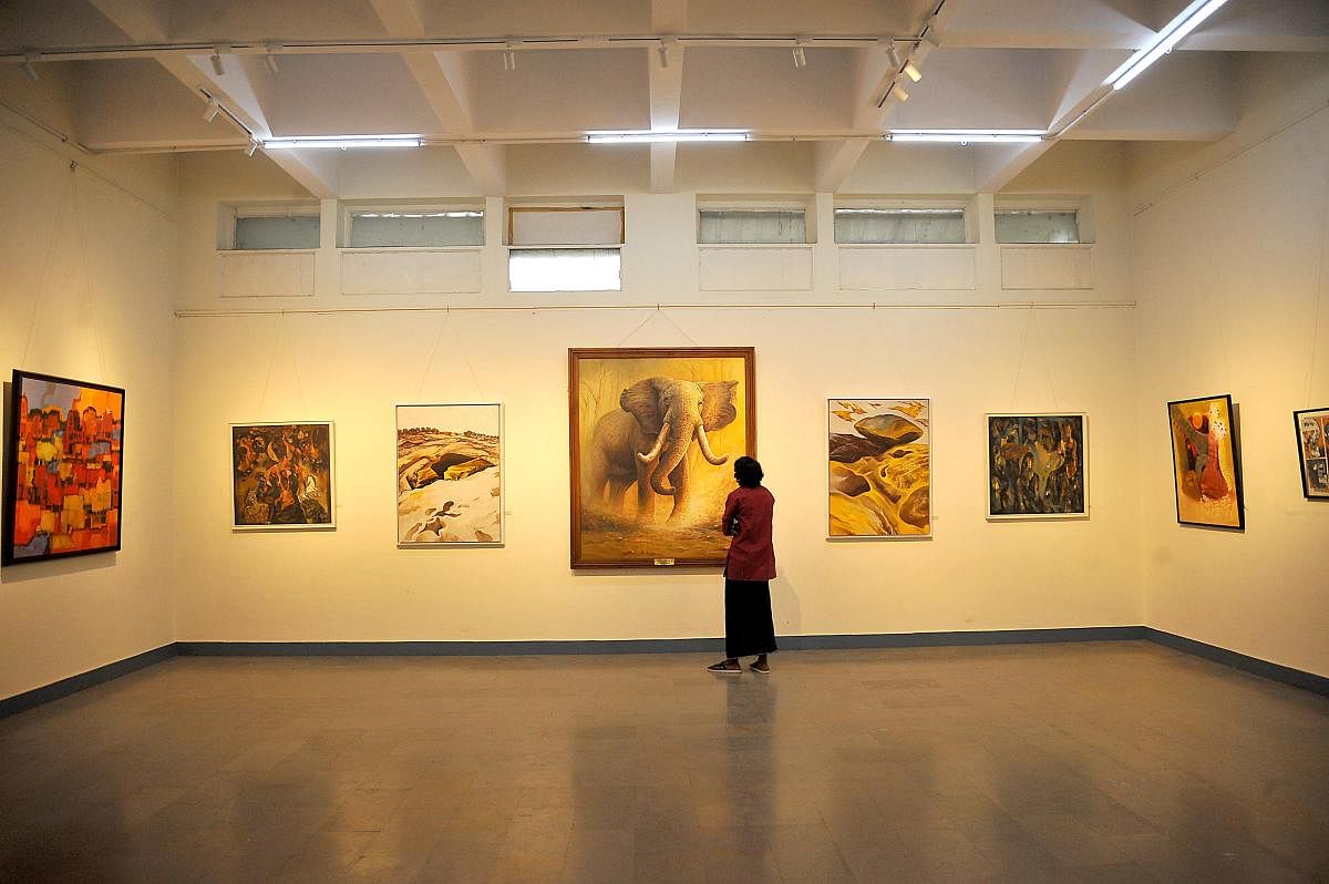 A man looks at an art work at the at the inauguration of the 18th Chitra Sante which is virtual this edition in Bengaluru on Sunday, Jan 03, 2021. DH Photo/Pushkar V