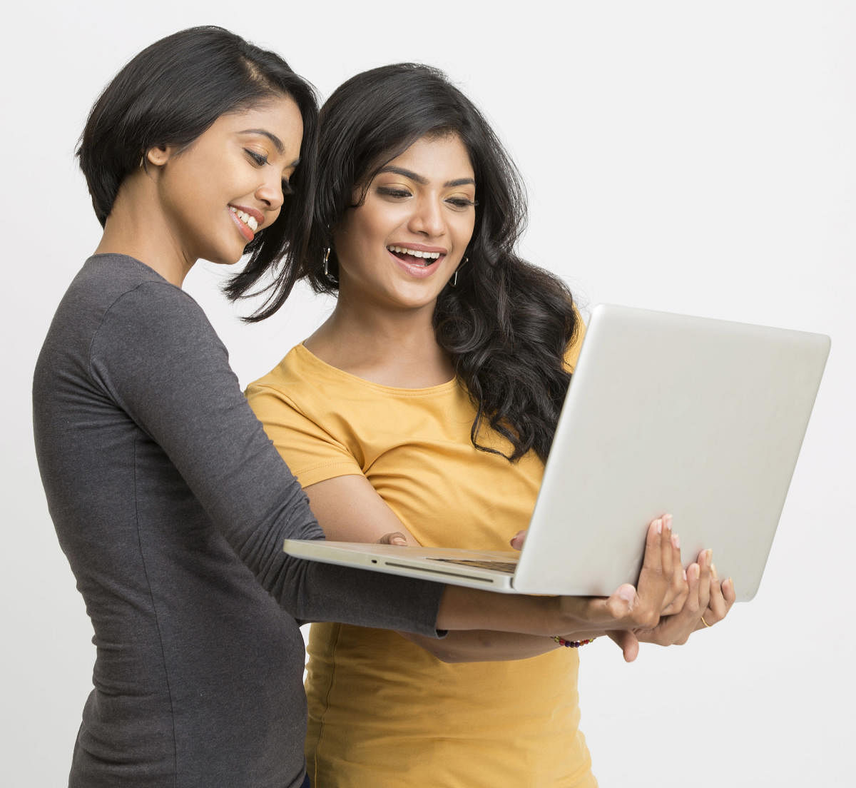 Two young women working in laptop on white backgroundiStock-524014106.jpg