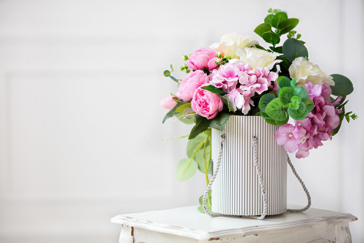 Beautiful peonies in a paper box on a white background.Beautiful peonies in a paper box on a white background