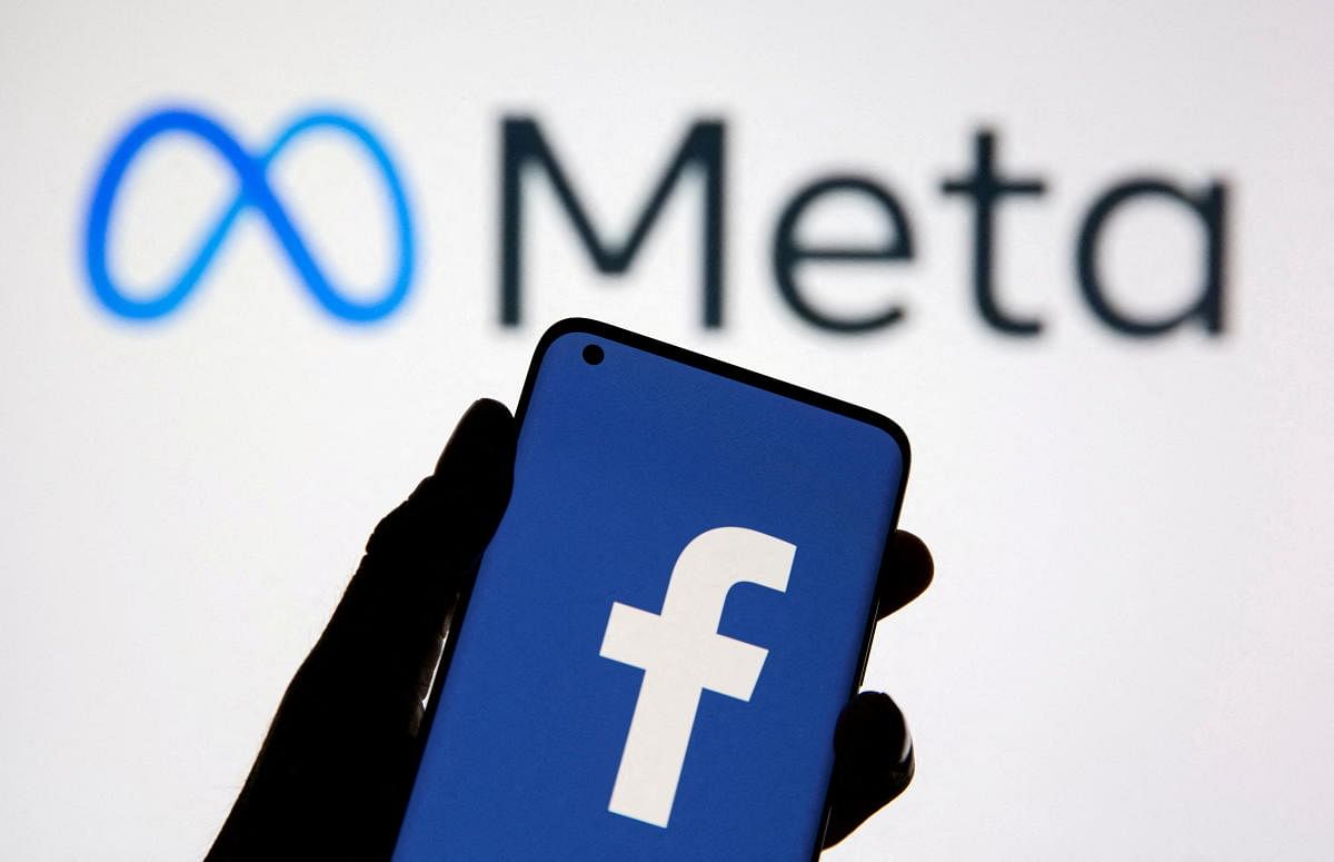 FILE PHOTO: A smartphone with Facebook's logo is seen in front of displayed Facebook's new rebrand logo Meta in this illustration taken October 28, 2021. REUTERS/Dado Ruvic/Illustration//File Photo