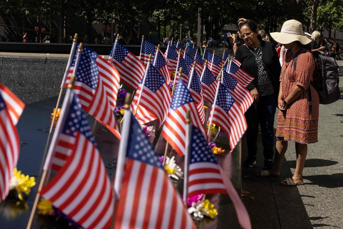 Visitors look at US flags on the 9/11 Memorial in New York, on September 10, 2022, one day before the 21st anniversary of the attacks on the World Trade Center, Pentagon, and Shanksville, Pennsylvania. 